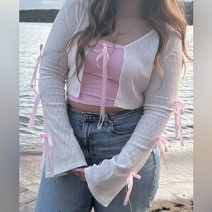 White sweater with light pink ribbon bows